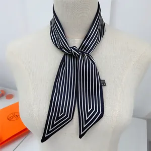Detail of blue and white striped silk scarf tied on mannequin showing satin texture