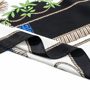 Close-up of printed silk floral scarf with rope pattern and elegant satin texture fold