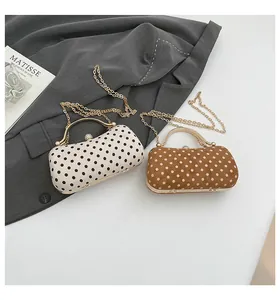 Polka dot evening clutch bags with gold metal frames and sparkling diamond clasp