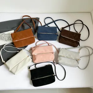Minimalist square envelope crossbody bag shown in seven elegant colors with metal zippers