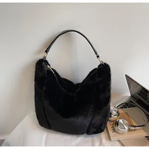 Detail of black faux fur tote bag showing golden ring hardware and plush texture