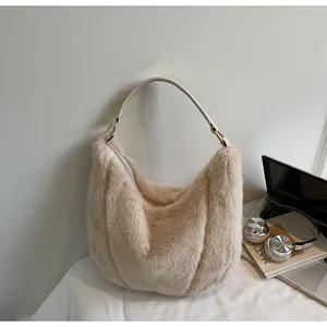 Close-up of the plush faux fur texture and leather strap of the hobo shoulder bag