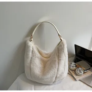 Detail of white plush tote bag with gold metal buckle and soft faux fur texture