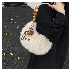 Detail of plush crescent bag with wooden bead handle and brown mini doll charm