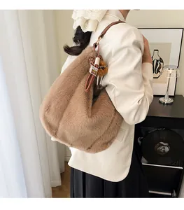 Détail d'un sac à bandoulière en peluche marron avec texture douce et pendentif ours