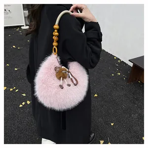 Pink faux fur crescent bag featuring unique wooden bead strap and plush bear charm