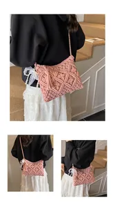 Close-up of pink hand-woven knit bag featuring intricate textures and decorative tassels
