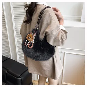 Detail of heart-shaped faux fur bag featuring leopard bow and beaded handle