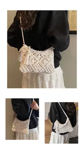 Detail of bohemian cream knit shoulder bag with long fringes and pearl lace accents
