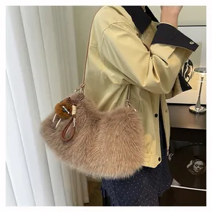 Detail showing plush brown faux fur texture and leather strap of the shoulder bag