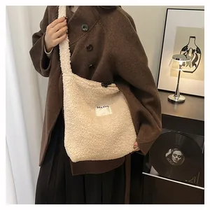 Detail of off-white fleece tote bag with SEEYOU embroidery and drawstring closure