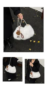 Plush white faux fur shoulder bag detail with a cute brown monster doll charm