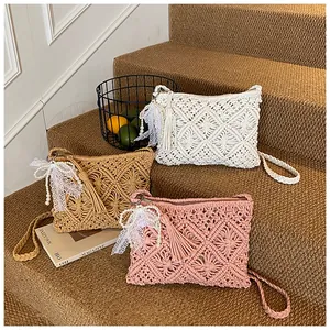Detail of woven knit crossbody bags featuring lace bows, tassels and pearl charms