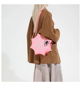 Detail of pink spider web shoulder bag with black spider accent on model's back
