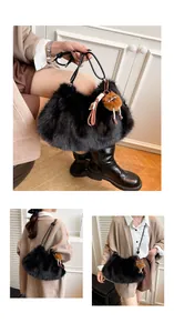 Detail of plush black cloud bag with fluffy texture and cute doll keychain accessory