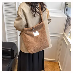 Detailed view of brown faux shearling tote bag with white SEEYOU letter embroidery patch