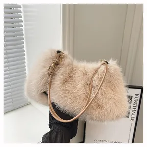 Detail of soft plush shoulder bag with fine faux fur texture and golden metal ring