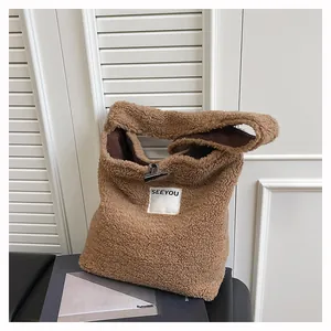 Detail of brown faux fur tote bag showing the plush texture and button closure