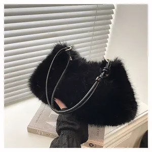 Detail of black faux fur shoulder bag with leather strap and golden metal ring hardware