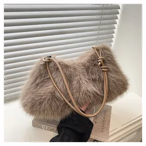 Detailed close-up of light brown plush faux fur texture and elegant gold ring hardware