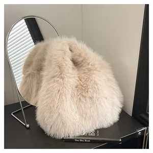 Dettaglio ravvicinato della trama di una borsa a secchiello in finta pelliccia color crema