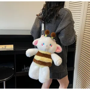 Detail of cute lamb-bee plush crossbody bag with soft long faux fur and white strap