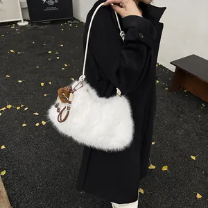 White faux fur shoulder bag with plush monkey charm and leather tassels for women