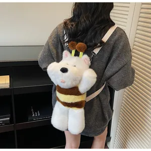 Detail of cute white plush bear backpack with bee stripes and antennae on a model
