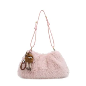 Chic pink faux fur shoulder bag with plush doll pendant and knotted strap detail