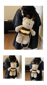 Detail of cute bear plush backpack with bee stripe pattern and soft fabric straps