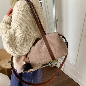 Vintage khaki faux suede cylinder baguette bag with dark brown leather straps and fur pompom