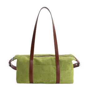 Green suede baguette shoulder bag with contrast brown straps and silver zipper