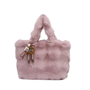 Borsa tote in ecopelliccia rosa con un simpatico ciondolo a forma di mostro marrone