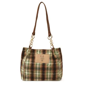 Green and brown plaid wool tote bag with leather straps and bear logo detail