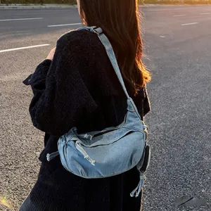 Retro gewaschene Denim-Umhängetasche in Halbmondform mit verstellbarem Gurt und Anhänger