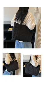 Detailed side view of black quilted tote bag featuring classic diamond stitching on nylon