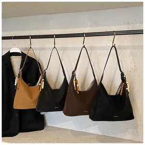 Detail of vintage tote bags with beaded zipper pulls hanging on a display rack