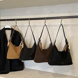 Faux suede hobo tote bag in solid colors with vintage wooden bead tassel detail