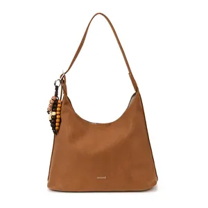 Brown vintage hobo tote bag with suede texture and ethnic wooden bead charm detail