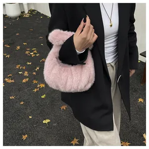 Detail of soft pink faux fur tote bag with plush handle and ruched texture design