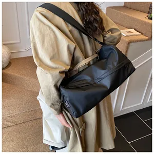 Détail d'un grand sac bandoulière noir en tissu Oxford avec bandoulière réglable