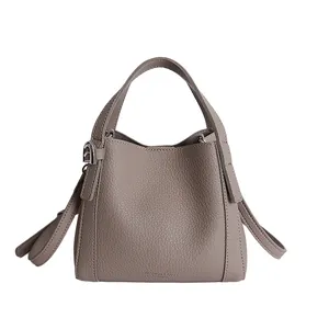 Large vintage taupe bucket bag in litchi grain leather with dual handles and shoulder strap