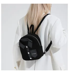 Close-up of black suede backpack featuring creative collar design and metal button detail