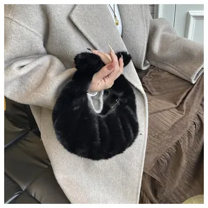 Detail of soft black faux fur hobo bag with textured striped plush and cozy handle