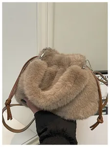 Detail of soft light brown faux fur bucket bag with leather strap and plush handle