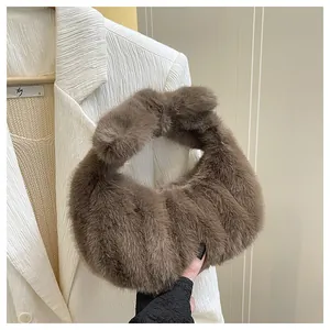 Detail view of brown faux fur texture on a soft pleated cloud handbag for winter styling