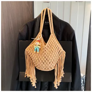 Detail van handgeweven tas met kwastjes en een schattige clown-hanger als decoratie