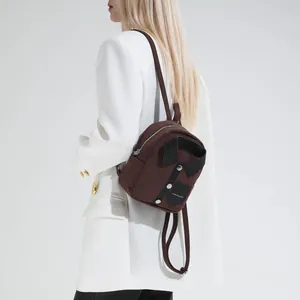 Minimalist brown suede backpack with creative shirt design on model in a studio setting