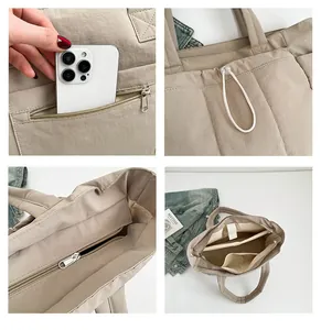 Detail view of beige quilted nylon tote with internal compartments and secure zipper