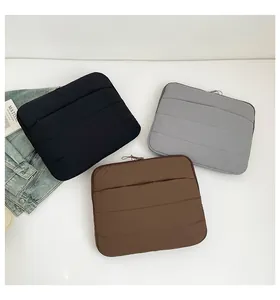 Three quilted laptop sleeves in black grey and brown colors with padded shockproof design